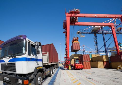 shipping-containers-being-loaded-onto-a-truck-2026-03-26-09-42-59-utc